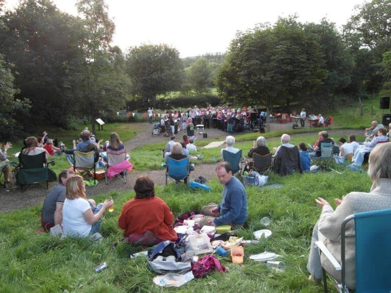 Community picnic gathering in the outdoor picnic area at Cookley Village Hall and fields.