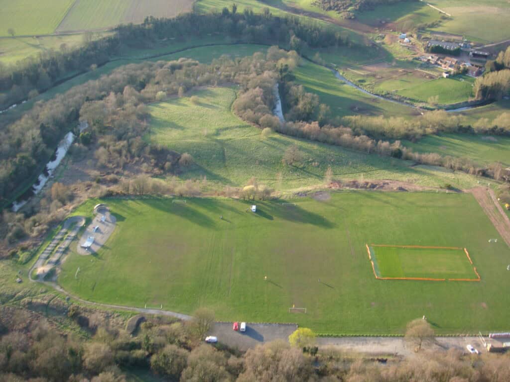 Aerial view of Cookley Village Hall and surrounding playing fields in a rural setting.