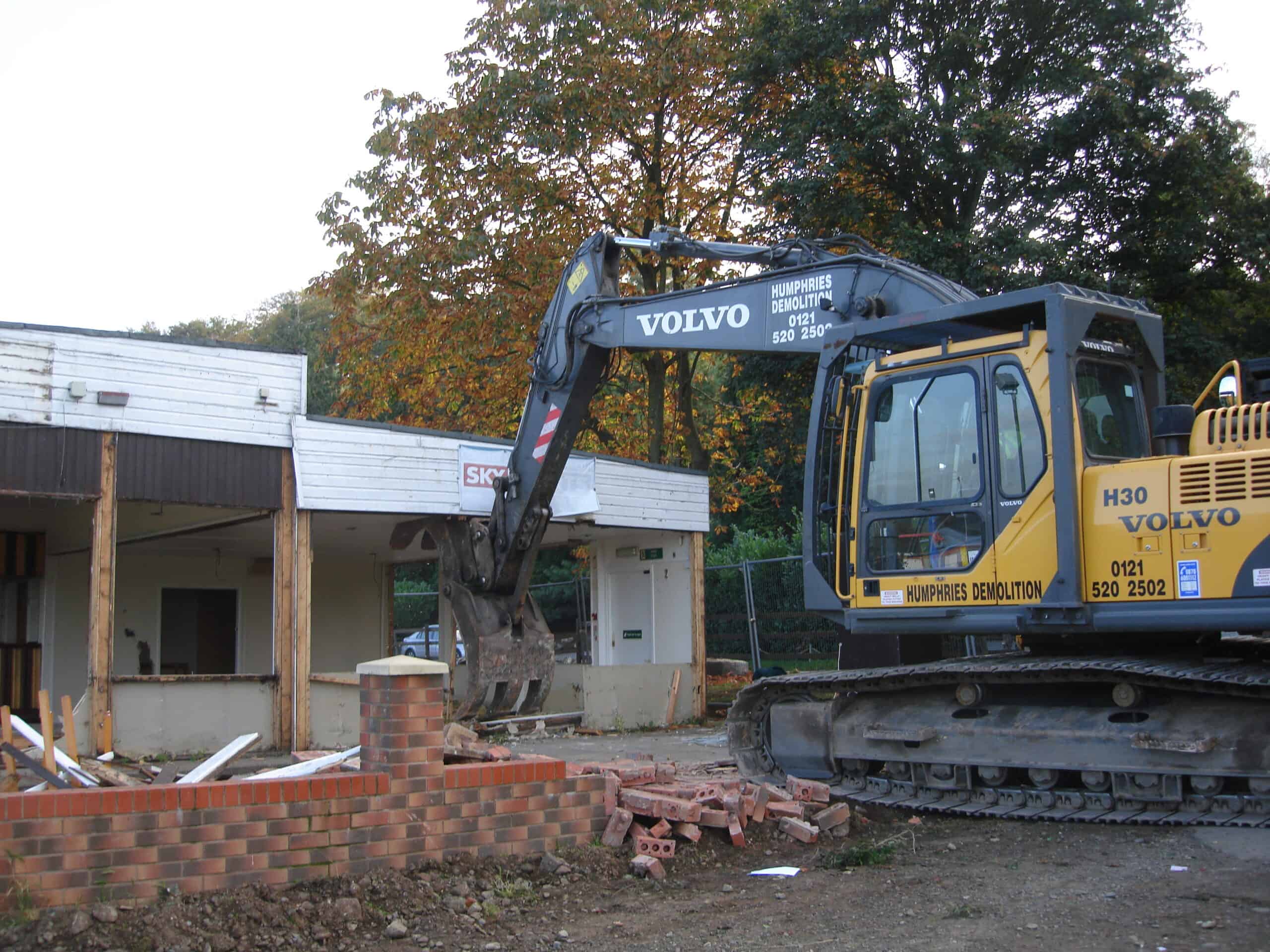 Excavator demolishing an old building at Cookley Village Hall and Playing Fields.
