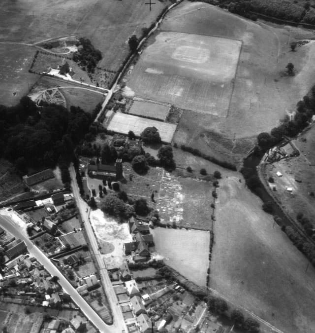 Aerial view of Cookley Village Hall and surrounding playing fields in black and white.