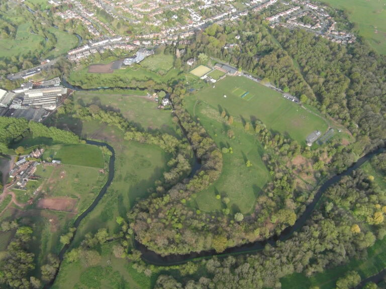 Aerial view of Cookley Village Hall and sports fields surrounded by lush greenery.