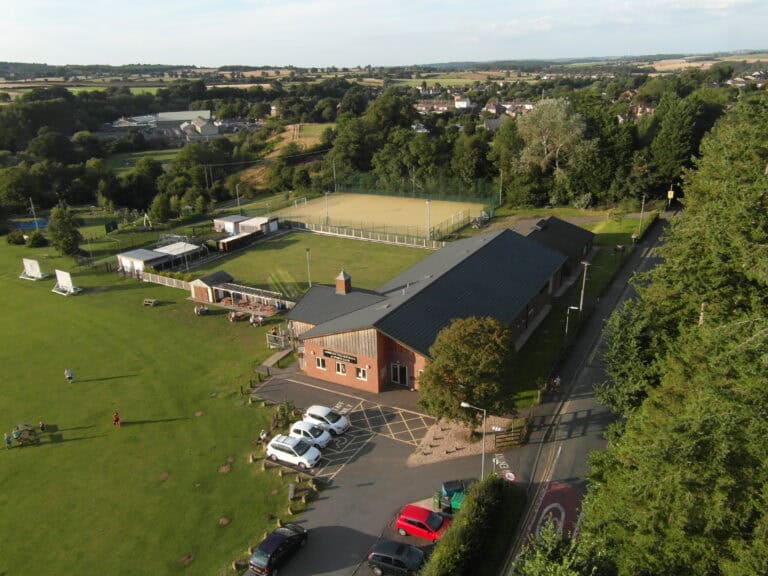 Aerial view of Cookley Village Hall and surrounding playing fields, tennis courts, and green spaces.